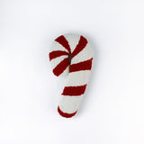 Candy cane–shaped decorative pillow with red and white stripes, made from a textured hooked fabric and displayed against a white background.
