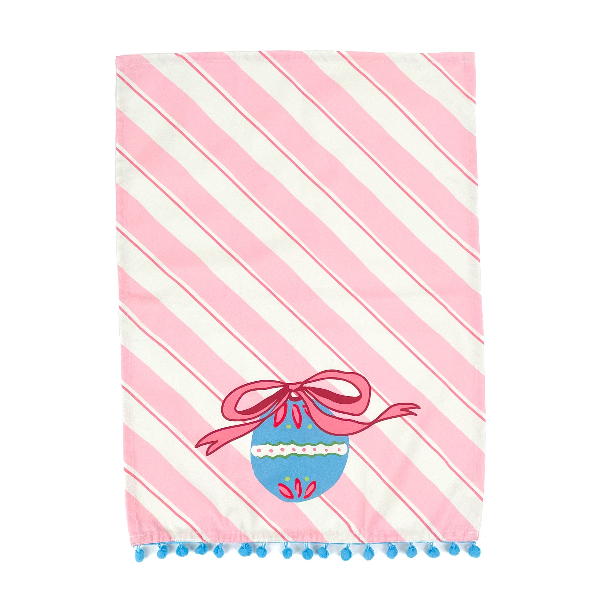 diagonally striped pink christmas tea towel with a large blue ornament motif at the bottom and blue pom pom trim against a white background. 