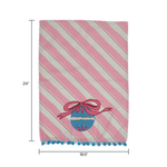 diagonally striped pink christmas tea towel with a large blue ornament motif at the bottom and blue pom pom trim against a white background and dimensions marked 24" x 18.5"