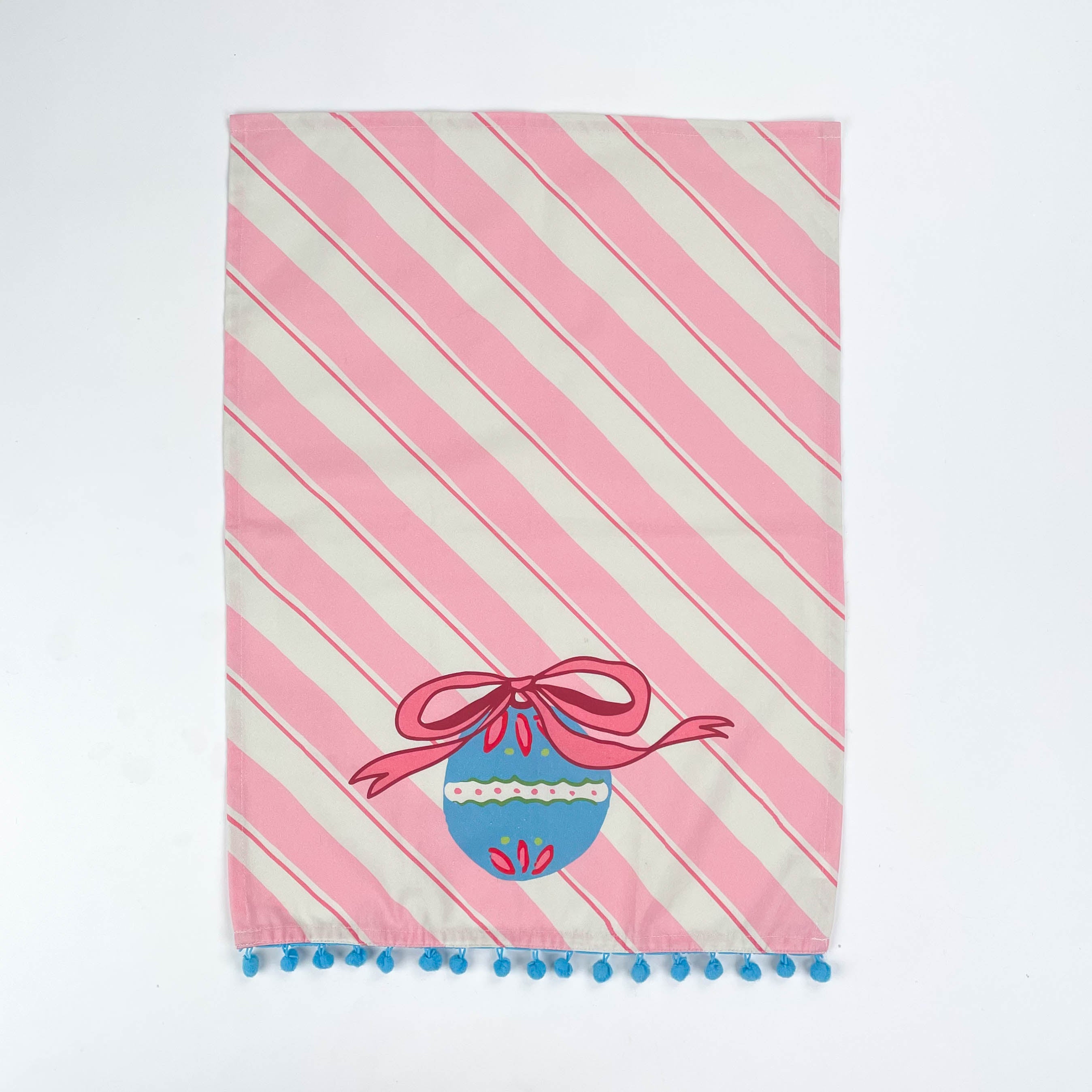 striped pink Christmas tea towel with a blue ornament and pink bow design on a white background