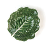 a ceramic cabbage leaf bowl top view in a white background