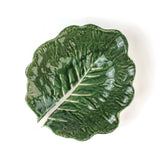 a ceramic cabbage leaf bowl top view in a white background