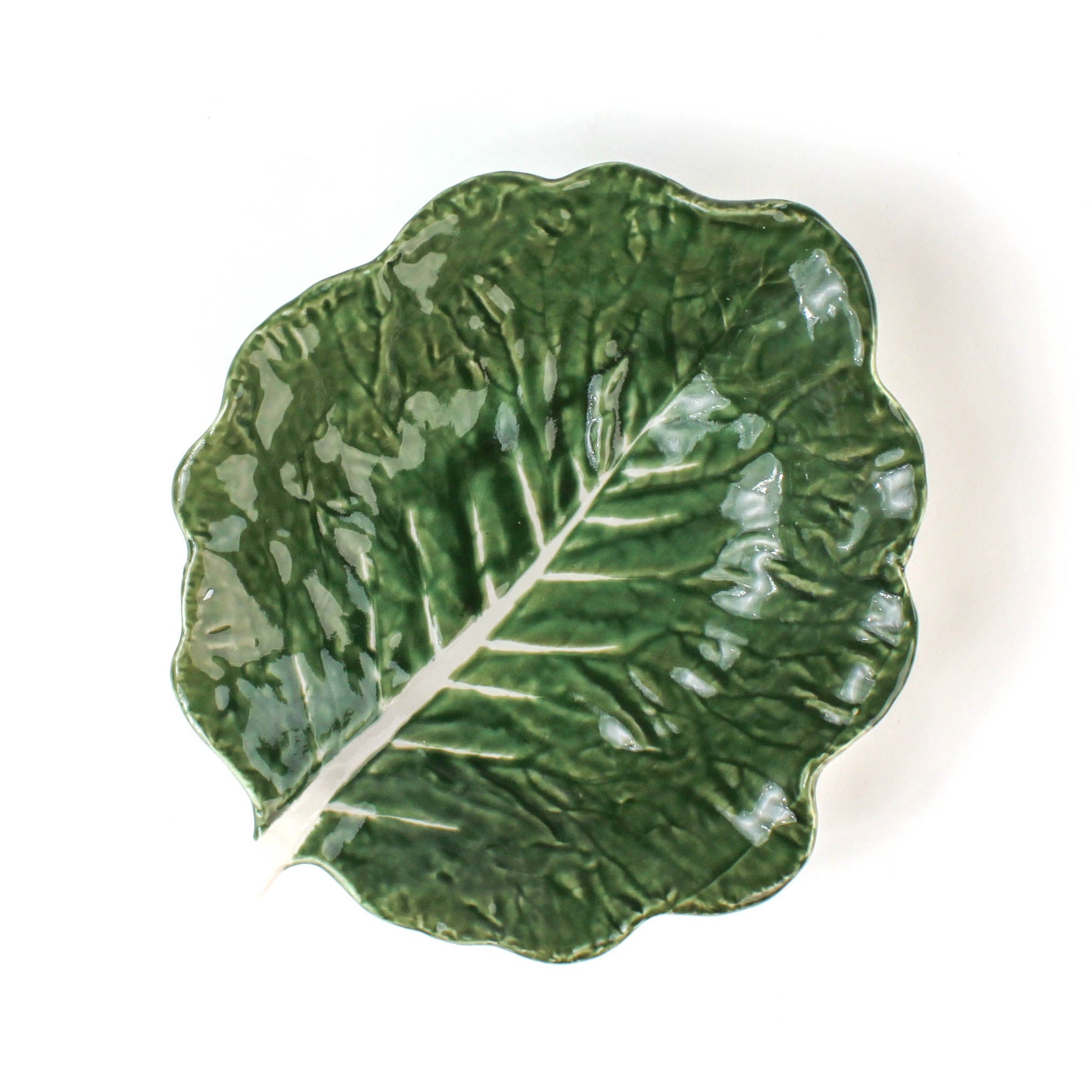 a ceramic cabbage leaf bowl top view in a white background