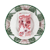 Red dragon cloth napkin folded on a white plate with green decorative charger, elegant holiday table setting perfect for Christmas tea towel styling, seasonal entertaining, and festive home décor