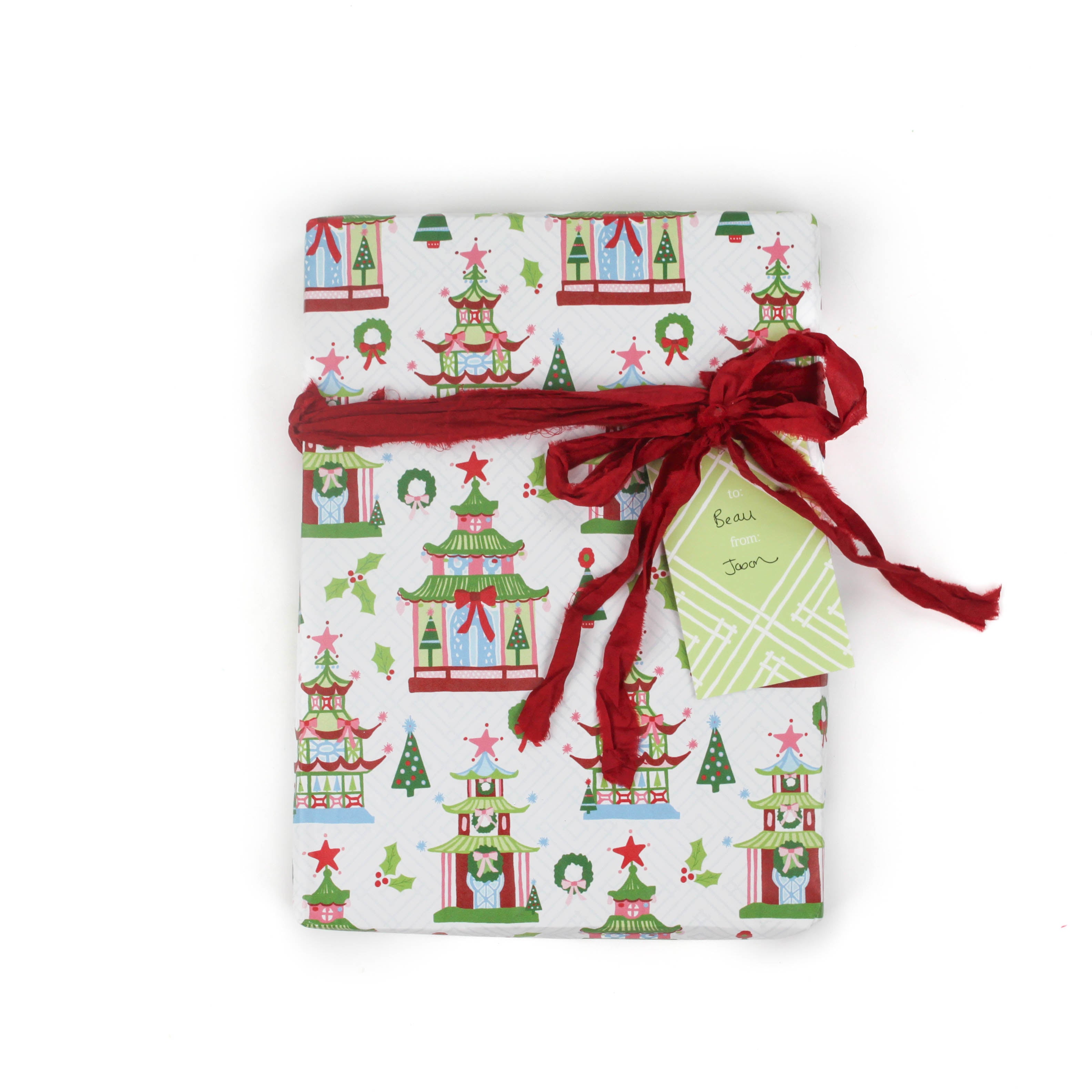 colorful Christmas wrapping paper featuring pagoda, holly and wreath motifs. 