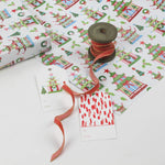 colorful Christmas wrapping paper featuring pagoda, holly and wreath motifs. 