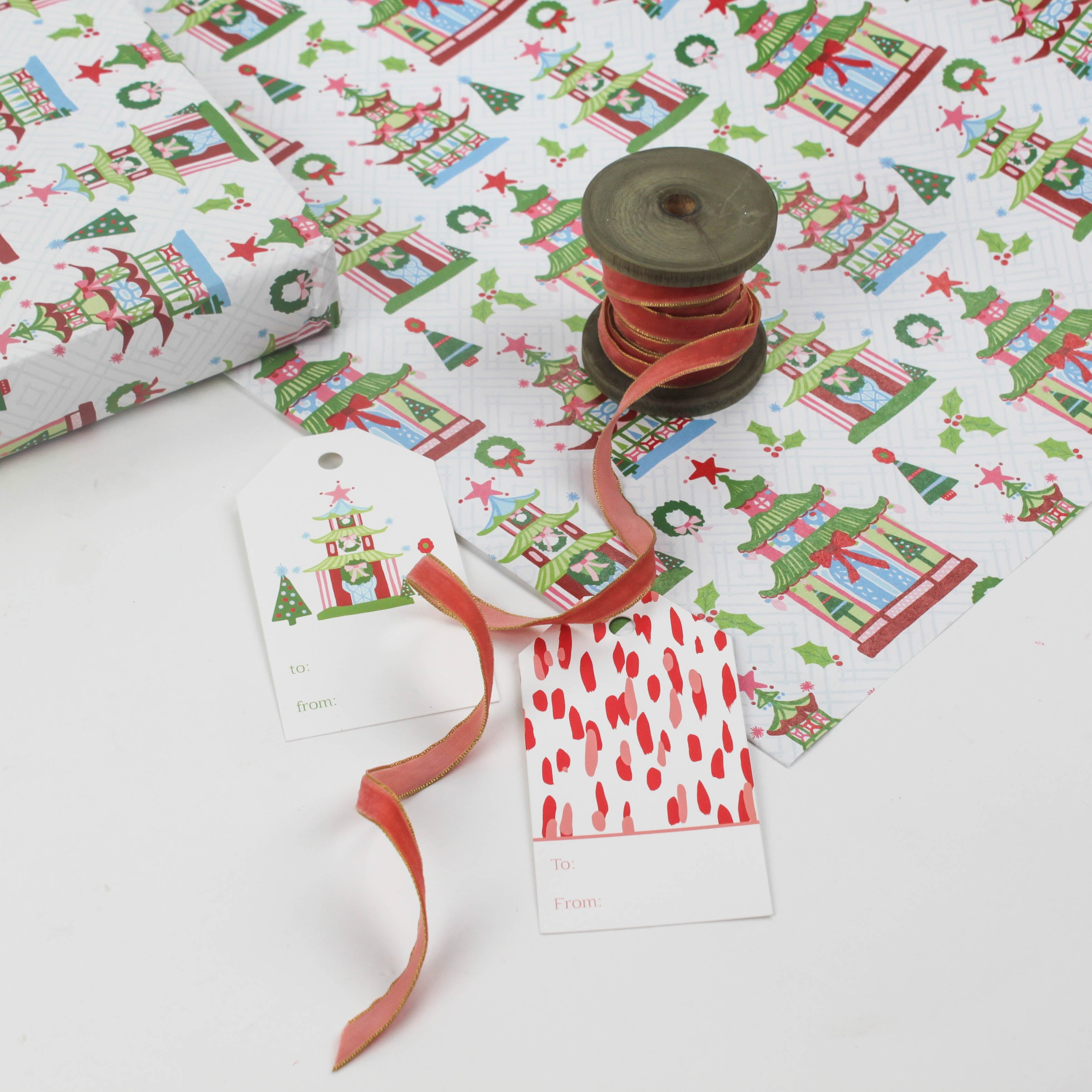 colorful Christmas wrapping paper featuring pagoda, holly and wreath motifs. 