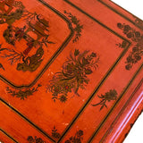 a dark wood chinoiserie side table with two tiers and on rolling casters.