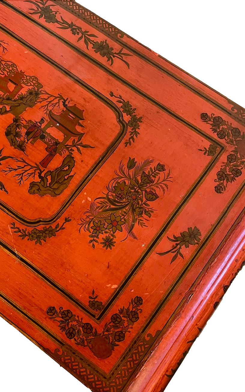 a dark wood chinoiserie side table with two tiers and on rolling casters.