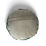 Back view of a round decorative pillow with a soft beige fabric and envelope-style closure.
