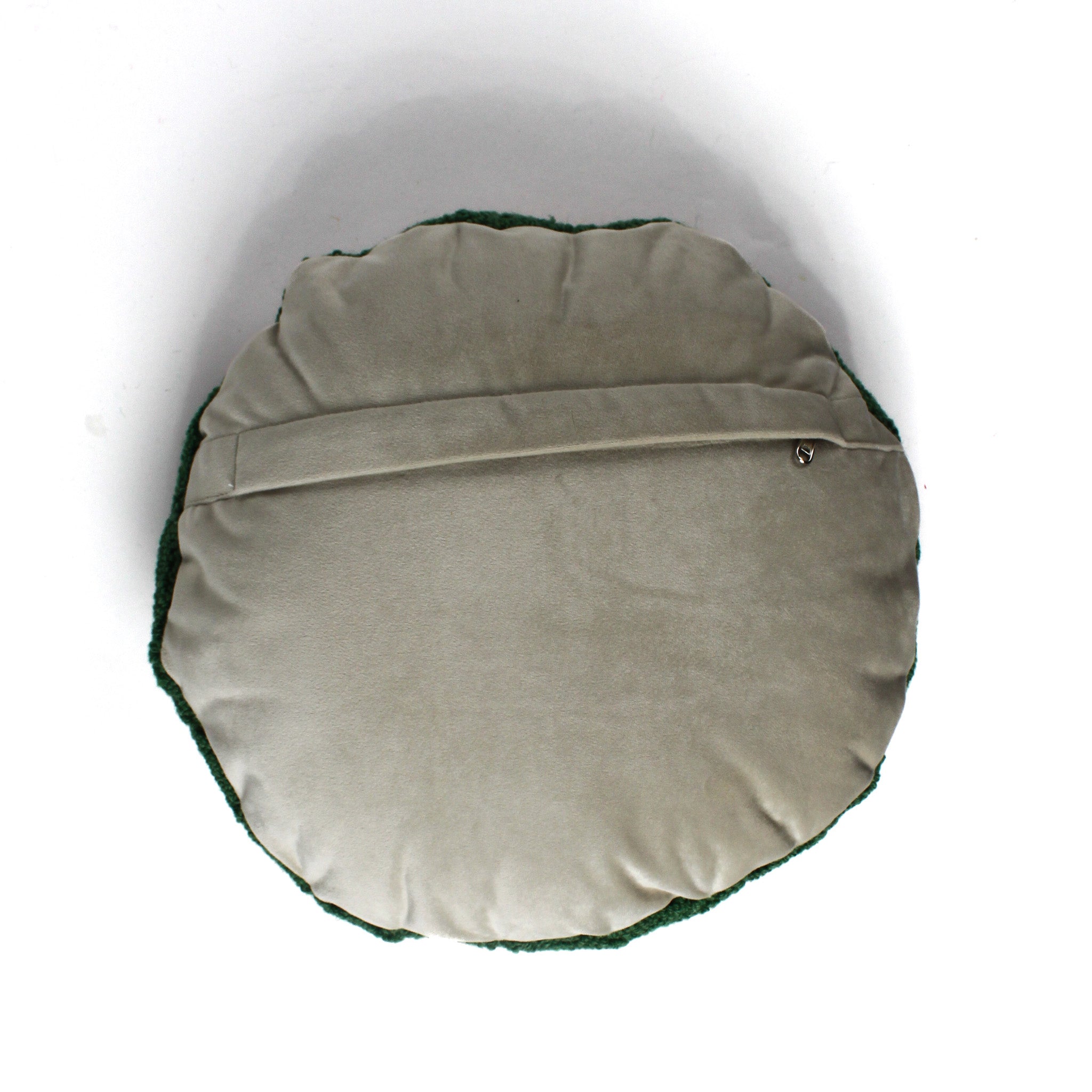 Back view of a round decorative pillow with a soft beige fabric and envelope-style closure.