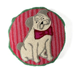 Front view of a round hooked pillow featuring a pug wearing a bow tie on a red and green background.