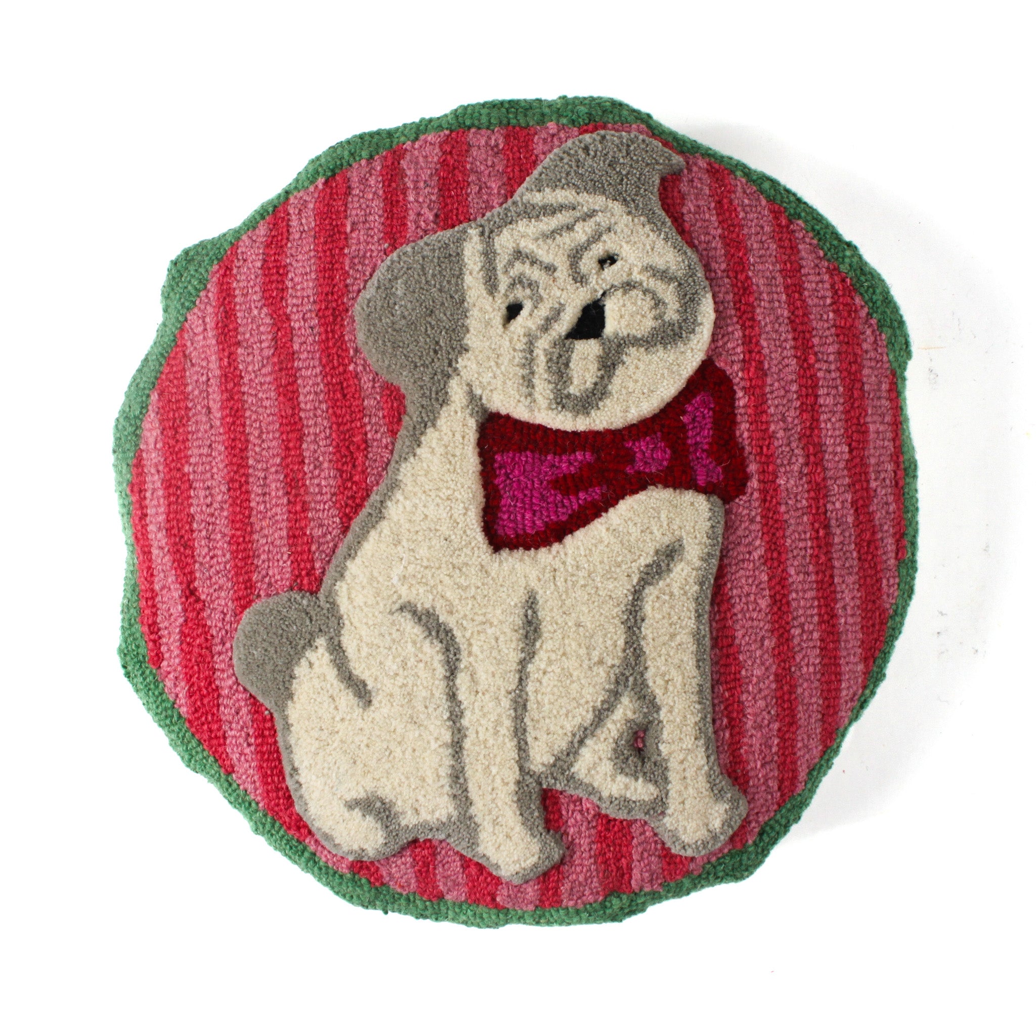 Front view of a round hooked pillow featuring a pug wearing a bow tie on a red and green background.