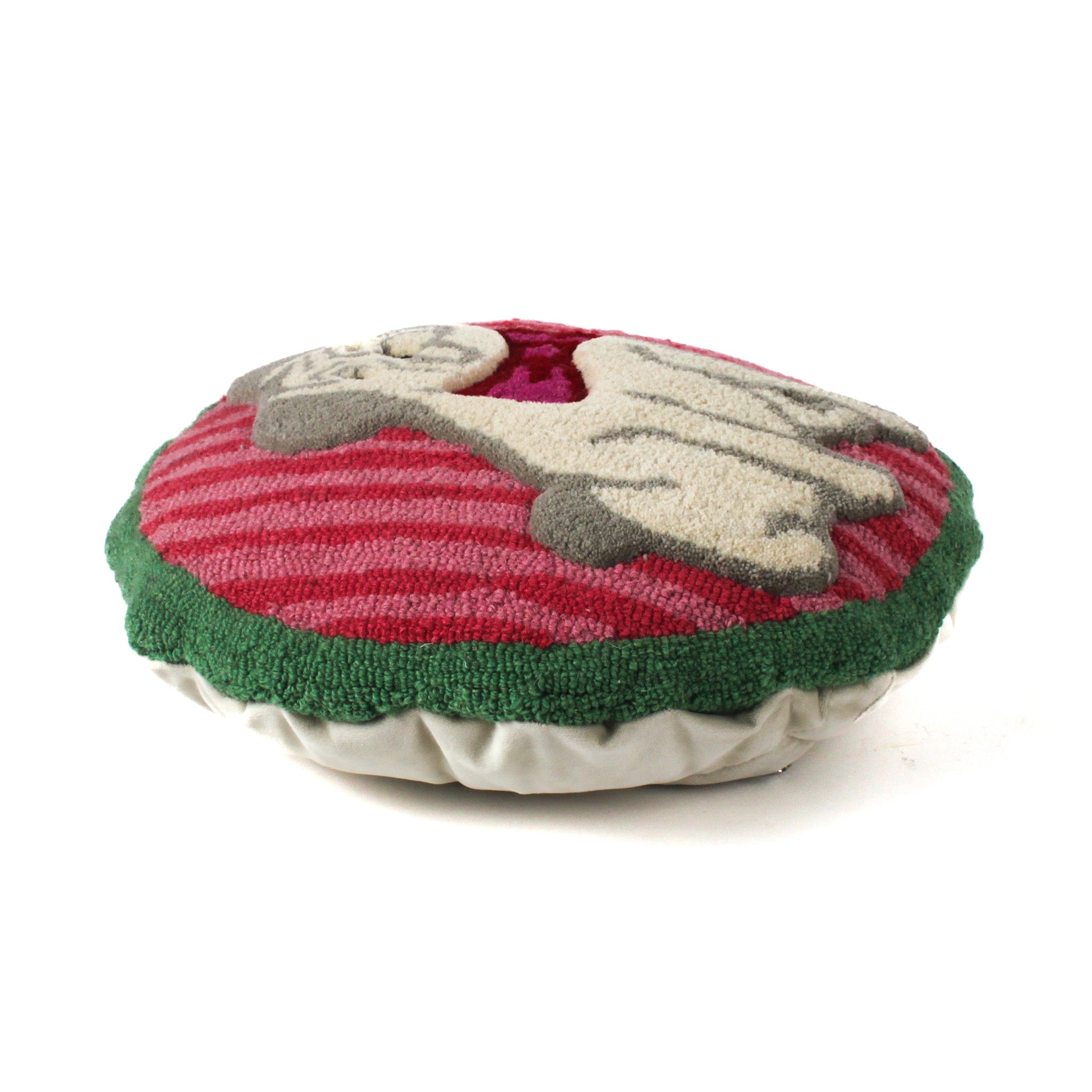 Side view of a round hooked pug pillow showing its textured front design and cushioned profile.
