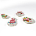 Four colorful snowman ceramic christmas plates on a white background