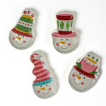 Four colorful snowman ceramic christmas plates on a white background