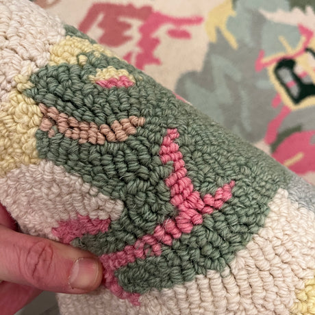 a close up of an Old Peking pink and green rug with chinoiserie motifs from madcap cottage