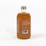 Bottle of 'The Perfect Mimosa' cocktail mix on a white background
