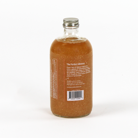Bottle of 'The Perfect Mimosa' cocktail mix on a white background