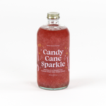 a bottle of candy cane peppermint mix. the contents are red and glittery and the label reads "Candy Cane Sparkle" 