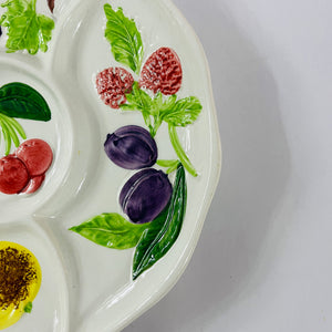 A white vintage strawberry pitcher with strawberry motifs decorating the side