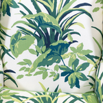 a vintage palm beach armchair covered in palm motif fabric 