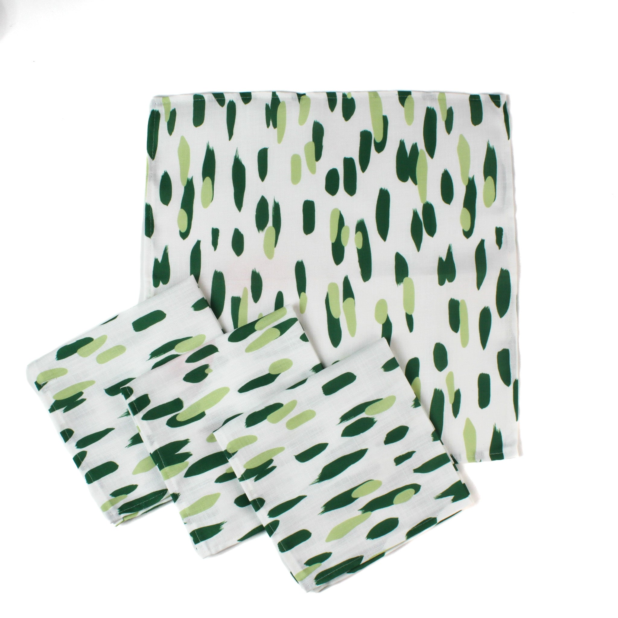 Set of four green brush stroke patterned dinner napkins on a white background, neatly stacked with stitched edges, designed for modern table settings and coordinated with a Christmas tea towel.