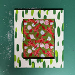 a green and white frame featuring a green brushtroke motif from madcap cottage
