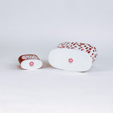 bottom of 2 madcap Cottage caddies with red abstract patterns on a white background