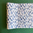 A blue and white paper table runner featuring a brushtroke pattern called Club House by Madcap Cottage