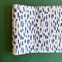 A blue and white paper table runner featuring a brushtroke pattern called Club House by Madcap Cottage