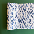 A blue and white paper table runner featuring a brushtroke pattern called Club House by Madcap Cottage