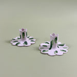 a pair of madcap cottage ceramic candle holders with scalloped edges and a green Club House print