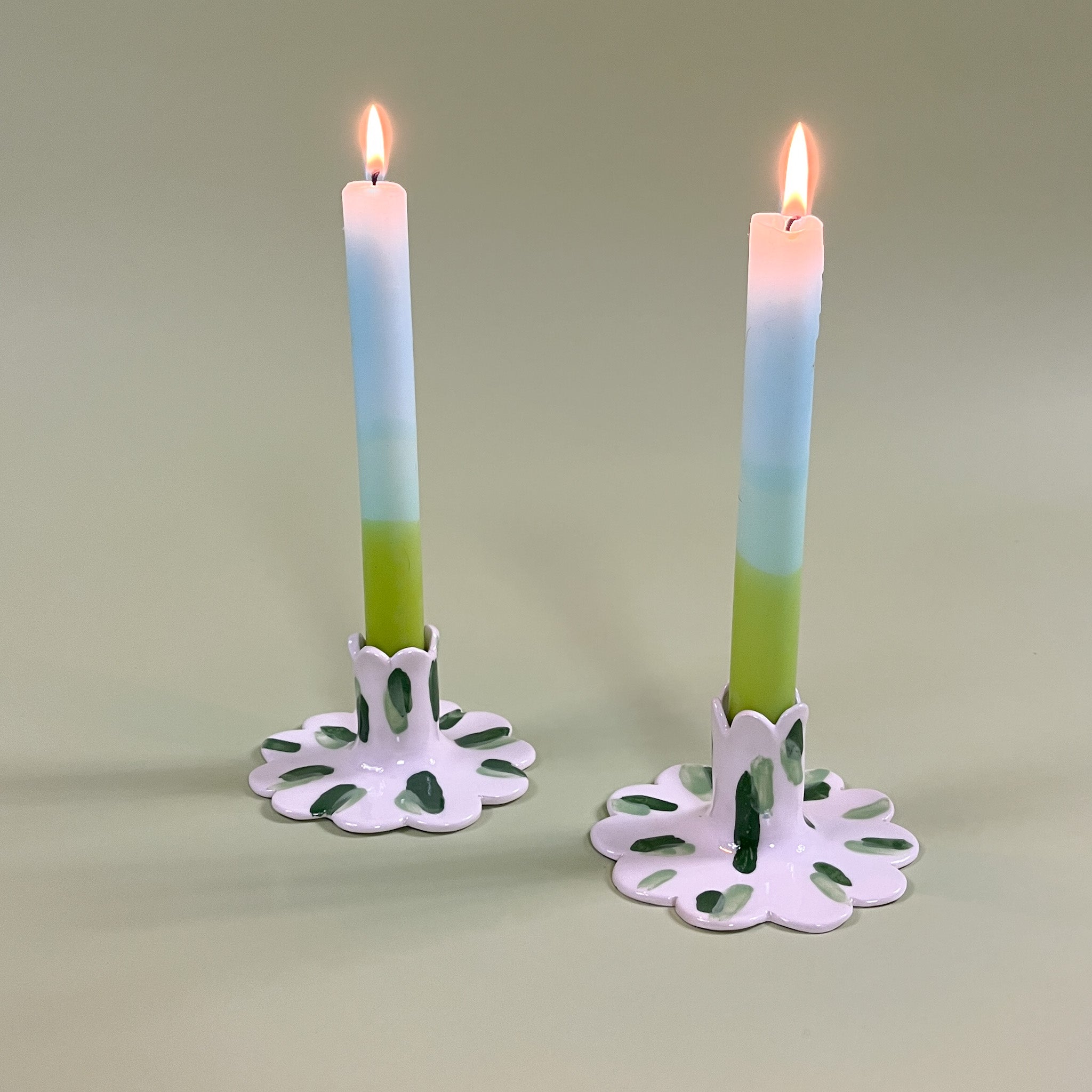 a pair of madcap cottage ceramic candle holders with scalloped edges and a green Club House print