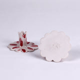 Pair of red and white ceramic petal-shaped candle holders with hand-painted red accents, designed for decorative tabletop display.