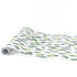 A green and white paper table runner with a brushtroke pattern on a white background