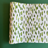 A green and white paper table runner with a brushtroke pattern