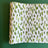 A green and white paper table runner with a brushtroke pattern