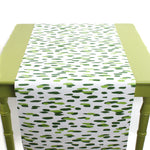 a green table covered with a green and white paper table runner with a brushtroke pattern