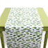 a green table covered with a green and white paper table runner with a brushtroke pattern