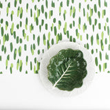 A cabbage plate on a green and white paper table runner with a brushtroke pattern