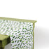 a green table covered with a green and white paper table runner with a brushtroke pattern