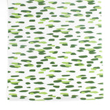 A green and white paper table runner with a brushtroke pattern