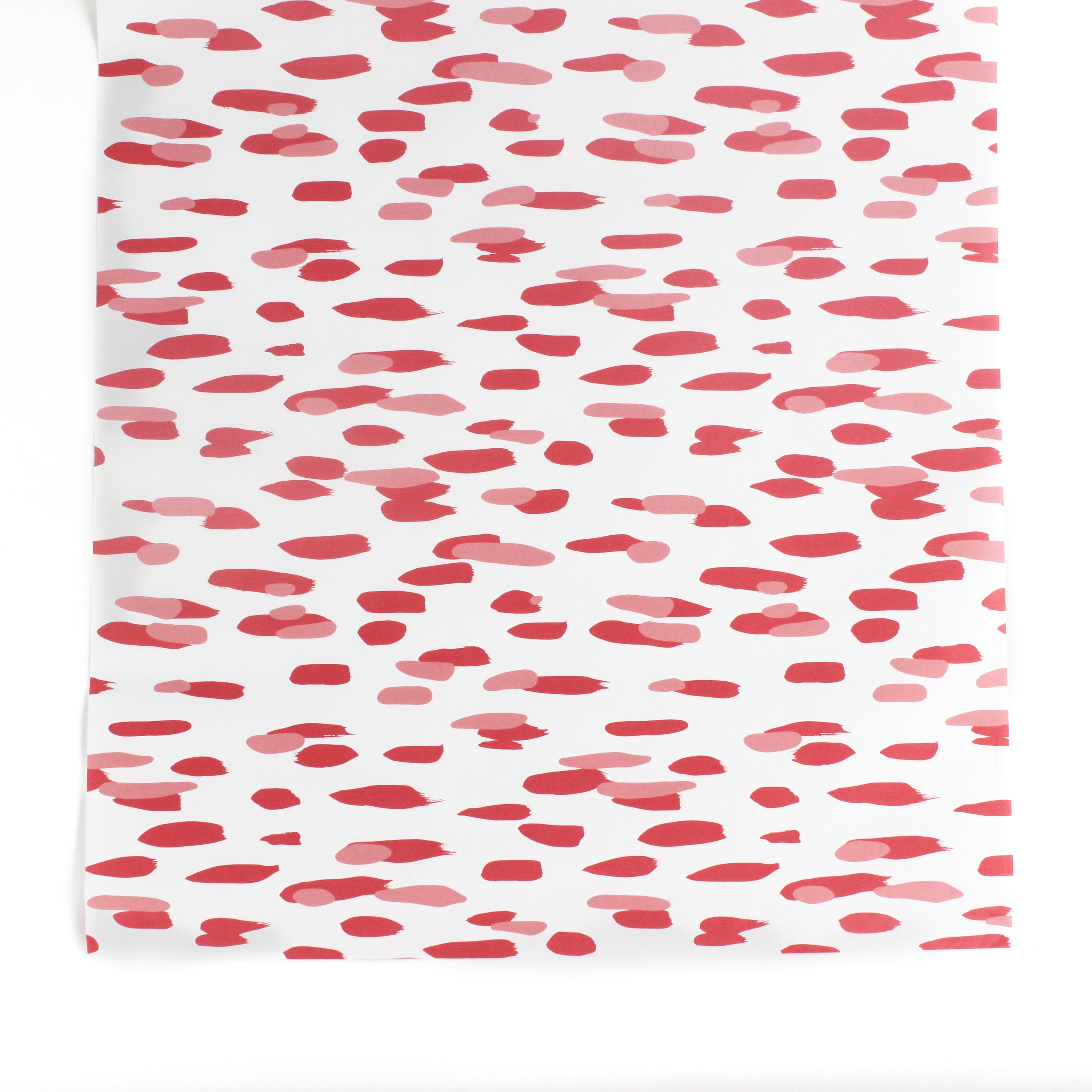 A pink and white paper table runner with a brushtroke pattern on a white background