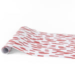 Clubhouse red paper table runner with abstract red brushstroke pattern design.