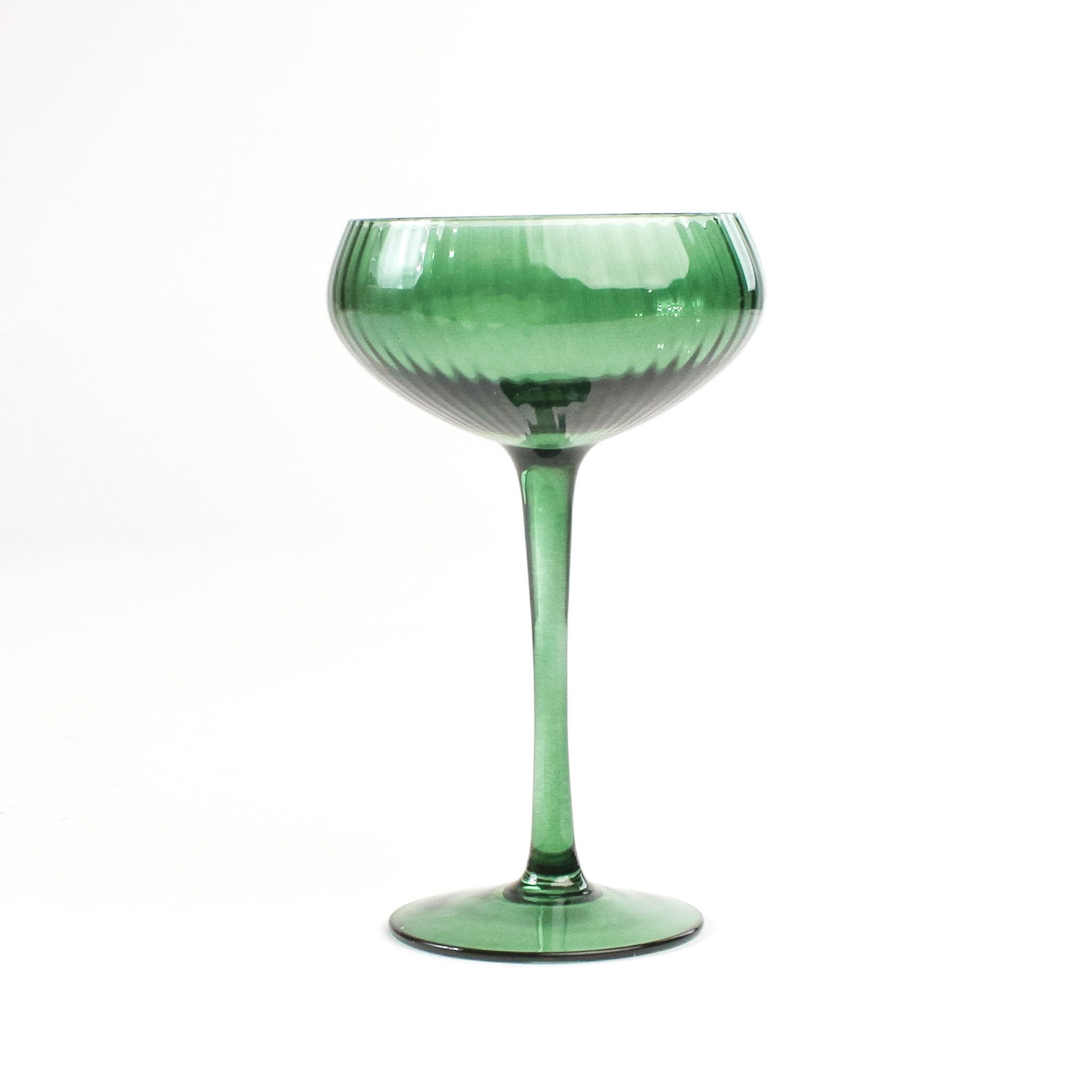 a green coupe glass from madcap cottage in a white background