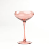 a pink coupe glass from madcap cottage in a white background