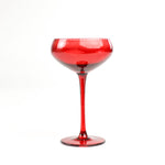 a red coupe glass from madcap cottage in a white background