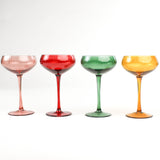 Set of Four Colored Champagne Glasses in yellow, green, pink and red in a white background