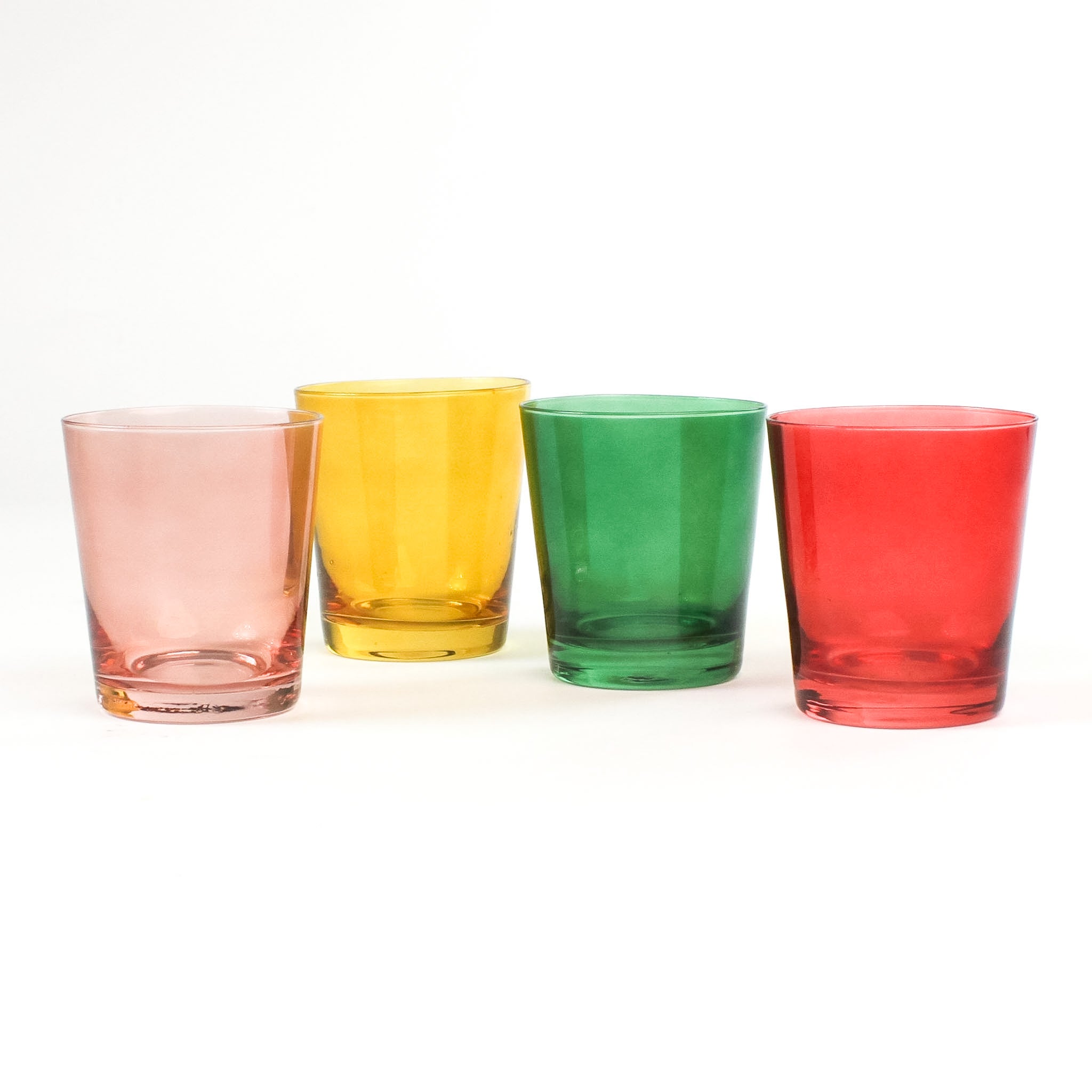 Four colored drinking glasses in pink, red, green and yellow from madcap cottage